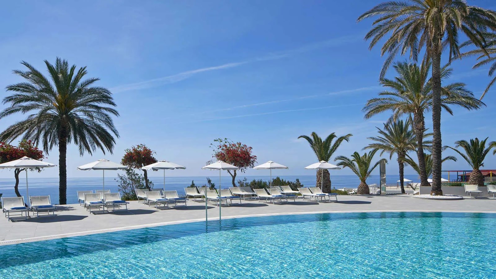 Swimming pool and palm trees overlooking the sea at Rodos Princess Beach in Kiotari, Rhodes