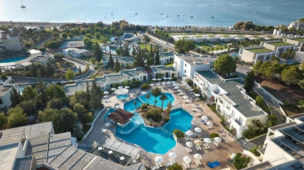 Aerial view of the pools and gardens of Kiotari Miraluna Beach Resort beside the sea in Kiotari, Rhodes